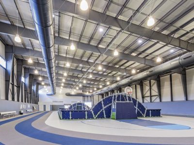 PEMB athletic facility with exposed steel interior