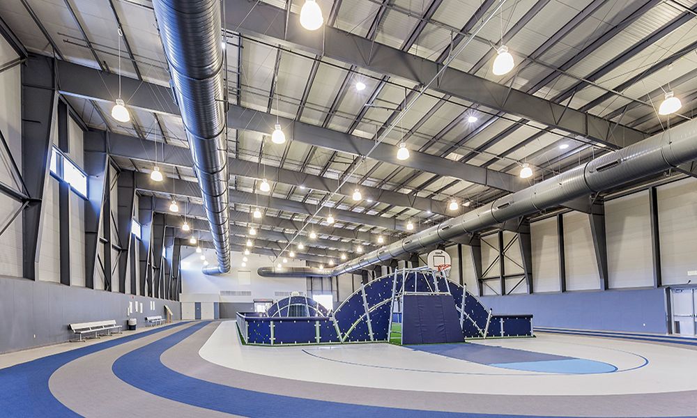 PEMB athletic facility with exposed steel interior