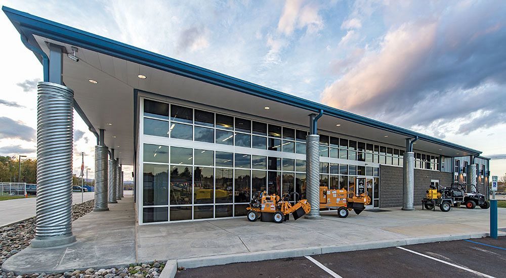 Custom designed equipment sales building with roof overhangs