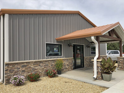 Below-eave canopy entrance to steel building vet clinic