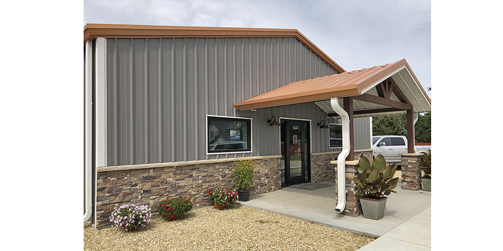 Below-eave canopy entrance to steel building vet clinic