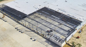 Standing seam roof being installed on a metal building
